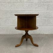 A Georgian walnut bookcase table of revolving barrel form having a circular piecrust tray top over