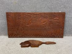 A 20th century South East Asian hand carved hardwood wall plaque depicting a column of soldiers