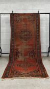 A 19th century Persian Lora runner having two central diamond lozenge medallions over an iron red