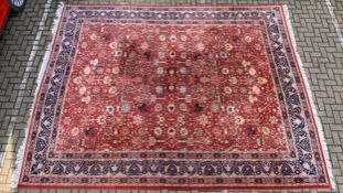 A very large 20th century Persian style Sarouk carpet having a scrolling foliate field over a