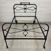 A Victorian cast iron and brass bead stead having a short brass top rail over a symmetrical openwork