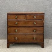 A Georgian mahogany and crossbanded chest of drawers having a rectangular top with a reeded edge