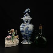 A possibly 19th century Dutch blue and white lidded delftware vase having a parrot finial over a