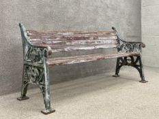 A heavy painted cast iron bench with distressed teak slats by Furnitube dated 1994. H.84 W.168 D.
