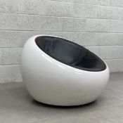 A 1960's Finnish half-dome or egg chair having a circular black leather upholstered bucket seat