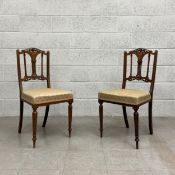 A pair of 19th century rosewood dining chairs each having a carved openwork cresting above a