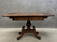 A Regency rosewood drop leaf sofa table having a rectangular top over two short frieze drawers