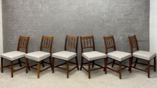 A set of six late Georgian mahogany dining chairs each having curved back with a slatted and pierced