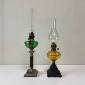 Two C.1900 Art Nouveau style brass and coloured glass oil lamps to include one with a tall clear
