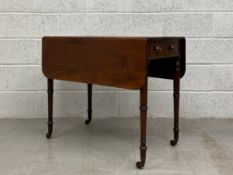 A late 18th century mahogany drop leaf Pembroke table having a rectangular top with a reeded edge