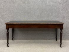 A 19th century mahogany console table having a rectangular tooled and gilt green leather moulded top