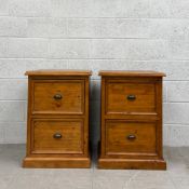 A pair of contemporary pine filing cabinets each having a square moulded top over two drawers raised