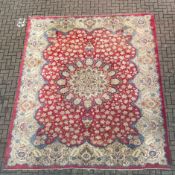 A very large Persian style Kashan carpet having a central geometric flowerhead medallion