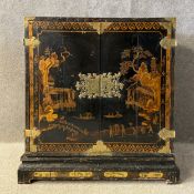 An 18th century Georgian black and gilt Japanned cabinet on stand having a rectangular top over a