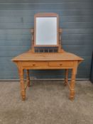 A C.1900 pine dressing table having a swing mirror with an arched pediment set into a turned