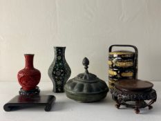 Six items to include a 20th century Chinese red cinnabar style vase raised on an openwork hardwood