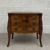A 19th century French Louis XV style chest of drawers of slight bombe form having a rectangular