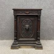 A Victorian carved oak side cabinet with a carved top above a single frieze drawer with a