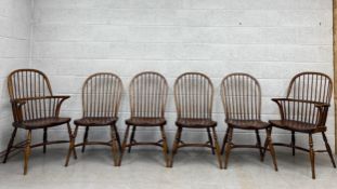 A set of six 20th century beech and elm stick back Windsor dining chairs including two carvers