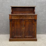A 19th century flame mahogany chiffonier having a shallow open top shelf with a pierced brass