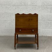 A Georgian mahogany Canterbury having a scalloped edge over a single frieze drawer raised on four