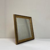 An early 20th century wall hanging mirror having a square plate in a gilt and ebonised reeded frame.
