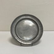 A 19th century pewter plate with indistinct maker's marks to the base. W.24cm