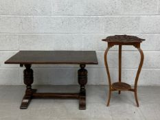 A small oak refectory style side table having a rectangular plank top raised on two carved cup and