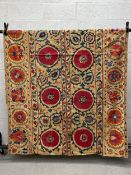 A large 19th century Uzbek hand embroidered needlework Suzani wall hanging in three panels having an