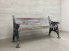 A heavy painted cast iron bench with distressed teak slats by Furnitube dated 1994. H.85 W.164 D.