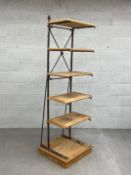 A 19th century French baker's shelving rack having five reclaimed pine shelves on a distressed