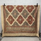 A large Persian hand dyed textile having a latticework field of scrolling geometric duck egg and