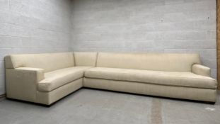A large contemporary corner sofa having a square stepped back and arms over an L-shaped cushioned