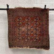 A small Afghan Baluch rug having five rows of three guls over an abrash red ground within multiple