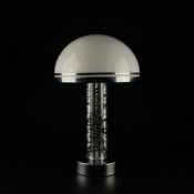 A mid century table lamp having a hemispherical milk glass 'mushroom' shade with a polished chrome