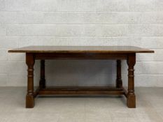 A Georgian country oak style refectory dining table having an aged and patinated rectangular plank
