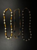 A collection of three necklaces to include a vintage Christian Dior gold plated metal mounted