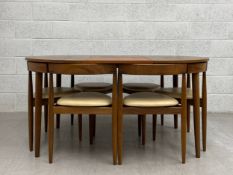 A 1960s Danish teak Roundette extending dining table with an integrated butterfly leaf and six