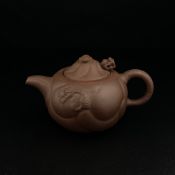 A 20th century Chinese Yixing Zisha clay 'Dragon Carp' teapot having a moulded lid with a cloud