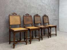 A set of four 19th century French oak hall or dining chairs each having a straight moulded top