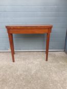A 19th century mahogany and crossbanded tea table having a square fold-over top with rounded corners