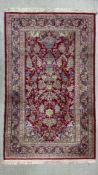 A 20th century hand knotted Kashmir prayer rug having an ascending flower filled vase over a