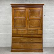 A 19th century walnut wardrobe having a moulded cornice with a reeded frieze above two panelled