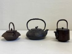 A collection of three 19th century and later Japanese cast iron Tetsubin to include one with an