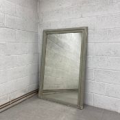 A large 19th century painted overmantel or pier mirror having a distressed rectangular plate in a
