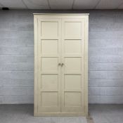 A large contemporary painted pine wardrobe having a rectangular top over two long panelled