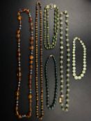 A collection of six necklaces to include a Chinese chatoyant tiger's eye beaded necklace with a gold