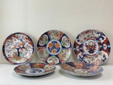 A collection of five 19th century and later Japanese porcelain Meiji period Imari chargers each hand