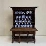 A miniature 19th century style oak Welsh dresser having a moulded cornice with a shaped apron over
