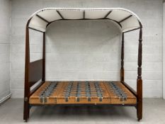 A 19th century mahogany four poster campaign bed with carved and turned supports. (Separates into